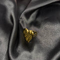 Gold ring on a dark gray fabric background