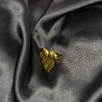 Gold ring on a dark gray fabric background