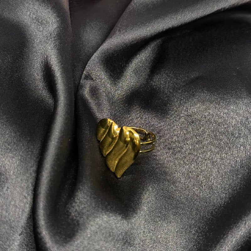 Gold ring on a dark gray fabric background